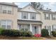 Inviting townhouse featuring a covered porch, blue shutters, and colorful landscaping at 10900 Wittenridge Dr # I4, Alpharetta, GA 30022