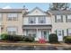 Lovely townhouse with blue shutters and blooming bushes enhancing its curb appeal at 10900 Wittenridge Dr # I4, Alpharetta, GA 30022