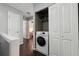 A hallway laundry closet on the second floor contains a front load washer dryer at 10900 Wittenridge Dr # I4, Alpharetta, GA 30022