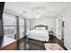 Spacious main bedroom with a ceiling fan, hardwood floors, and a view from multiple windows at 10900 Wittenridge Dr # I4, Alpharetta, GA 30022