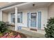 Cozy front porch featuring seating area and a welcoming entrance with vibrant flower bed at 10900 Wittenridge Dr # I4, Alpharetta, GA 30022