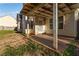 Covered back porch perfect for outdoor dining and relaxation at 113 Highgrove Pl, Mcdonough, GA 30253