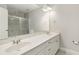 Bathroom featuring double sinks, large mirror and tiled shower for a luxurious feel at 113 Highgrove Pl, Mcdonough, GA 30253