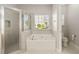Bathroom features a walk-in shower, a soaking tub, and a toilet, offering comfort and functionality at 113 Highgrove Pl, Mcdonough, GA 30253