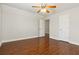 Bedroom with hardwood floors, a ceiling fan, and a spacious closet for ample storage at 113 Highgrove Pl, Mcdonough, GA 30253
