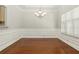 Formal dining room with elegant chandelier and wainscoting at 113 Highgrove Pl, Mcdonough, GA 30253
