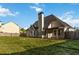Home exterior showcasing a spacious yard, covered porch, and mature trees at 113 Highgrove Pl, Mcdonough, GA 30253