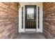Close-up of a classic front door with glass inserts, flanked by sidelights and stone surround at 113 Highgrove Pl, Mcdonough, GA 30253