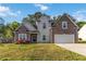 Charming two-story home featuring a stone and siding facade, a well-manicured lawn, and an attached two-car garage at 113 Highgrove Pl, Mcdonough, GA 30253