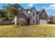 Beautiful two-story home with stone and siding details, an attached garage, and a vibrant front garden at 113 Highgrove Pl, Mcdonough, GA 30253