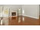 Bright living room with hardwood floors, a cozy fireplace, and views to the backyard at 113 Highgrove Pl, Mcdonough, GA 30253