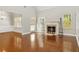 Open living room with hardwood floors and fireplace, perfect for entertaining or relaxing at 113 Highgrove Pl, Mcdonough, GA 30253