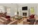 Comfortable living room featuring a fireplace, ample seating, and natural light at 113 Highgrove Pl, Mcdonough, GA 30253
