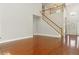 Open concept living room boasting shiny hardwood floors, a staircase to the second floor, and a two story ceiling at 113 Highgrove Pl, Mcdonough, GA 30253