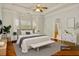 Main bedroom space is furnished with a gray bed and bench, accompanied by matching nightstands and decor at 113 Highgrove Pl, Mcdonough, GA 30253