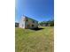 Nice backyard showcasing a well-manicured lawn and a two-story home with great outdoor potential at 205 Sullivan St, Hampton, GA 30228