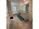 Bright bathroom featuring double vanity, tub, and large window for natural light at 205 Sullivan St, Hampton, GA 30228
