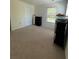 Bright bedroom featuring neutral carpet, light walls, and a large window at 205 Sullivan St, Hampton, GA 30228