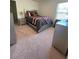 Comfortable bedroom featuring carpet, bed with grey and red accents, and natural light at 205 Sullivan St, Hampton, GA 30228