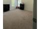 Bright bedroom featuring neutral carpet, light walls, and plenty of natural light at 205 Sullivan St, Hampton, GA 30228