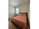 Bedroom featuring a bed with a colorful striped comforter and natural light from a window at 205 Sullivan St, Hampton, GA 30228