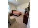 Bright bedroom featuring a bed with striped comforter, side table, and dresser at 205 Sullivan St, Hampton, GA 30228