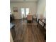 A dining area features a table with four chairs and a door leading to the outside at 205 Sullivan St, Hampton, GA 30228