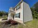A two-story home presents a charming exterior with a manicured lawn and a mix of beige and tan siding at 205 Sullivan St, Hampton, GA 30228