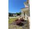 The home features manicured landscaping around a covered porch, complementing its exterior with a well-kept lawn at 205 Sullivan St, Hampton, GA 30228