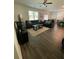 Cozy living room with large sectional sofa, area rug, and plenty of natural light at 205 Sullivan St, Hampton, GA 30228