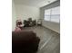 Cozy living room showcases hardwood floors, neutral paint and window at 205 Sullivan St, Hampton, GA 30228