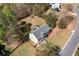 Aerial view of home with large backyard, swing set, mature trees, and landscaping at 33 Blue Springs Way, Dallas, GA 30157