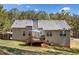 Exterior of the home with a wooden deck and landscaped backyard at 33 Blue Springs Way, Dallas, GA 30157