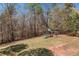 Backyard with a playset and partially fenced yard, offering ample space for recreation and outdoor activities at 33 Blue Springs Way, Dallas, GA 30157