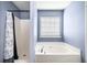 Bright bathroom featuring soaking tub and separate shower at 33 Blue Springs Way, Dallas, GA 30157