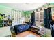 A cozy bedroom with green vines, fairy lights, and a window view at 33 Blue Springs Way, Dallas, GA 30157