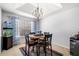 Inviting dining room with a round table, chandelier, and bright natural light from a window at 33 Blue Springs Way, Dallas, GA 30157