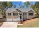 Charming two-story home featuring a two-car garage, a well-manicured front yard, and inviting curb appeal with mature trees at 33 Blue Springs Way, Dallas, GA 30157