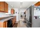 Kitchen with stainless steel fridge, wood cabinets, and view to the dining area at 33 Blue Springs Way, Dallas, GA 30157