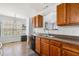 Functional kitchen features wood cabinets, a black dishwasher, and a window overlooking the backyard at 33 Blue Springs Way, Dallas, GA 30157