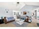 Open-concept living room with vaulted ceiling, a comfortable seating area, and seamless flow into the adjacent dining area at 33 Blue Springs Way, Dallas, GA 30157