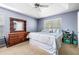Spacious main bedroom with a large bed, dresser, ceiling fan, and ample natural light at 33 Blue Springs Way, Dallas, GA 30157