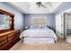 Comfortable main bedroom featuring a tray ceiling, large bed, and classic wooden dresser at 33 Blue Springs Way, Dallas, GA 30157