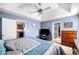 Comfortable main bedroom featuring tray ceiling, TV, and warm tones at 33 Blue Springs Way, Dallas, GA 30157