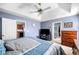 Comfortable main bedroom with a ceiling fan and views into the kitchen and bathroom at 33 Blue Springs Way, Dallas, GA 30157