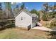 Side view of the house featuring a two-car garage, fenced yard, and a well-manicured lawn at 33 Blue Springs Way, Dallas, GA 30157