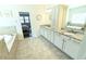 Spacious bathroom featuring dual sinks, soaking tub, and tiled floors at 4881 Belle Estates Rd, Suwanee, GA 30024
