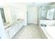 Bright bathroom features a double sink vanity, walk-in shower, and separate soaking tub at 4881 Belle Estates Rd, Suwanee, GA 30024