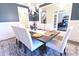 Elegant dining room with modern chandelier and white chairs surrounding a wooden table at 4881 Belle Estates Rd, Suwanee, GA 30024