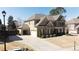 Beautiful two-story brick home with a three car garage and well-maintained landscaping at 4881 Belle Estates Rd, Suwanee, GA 30024